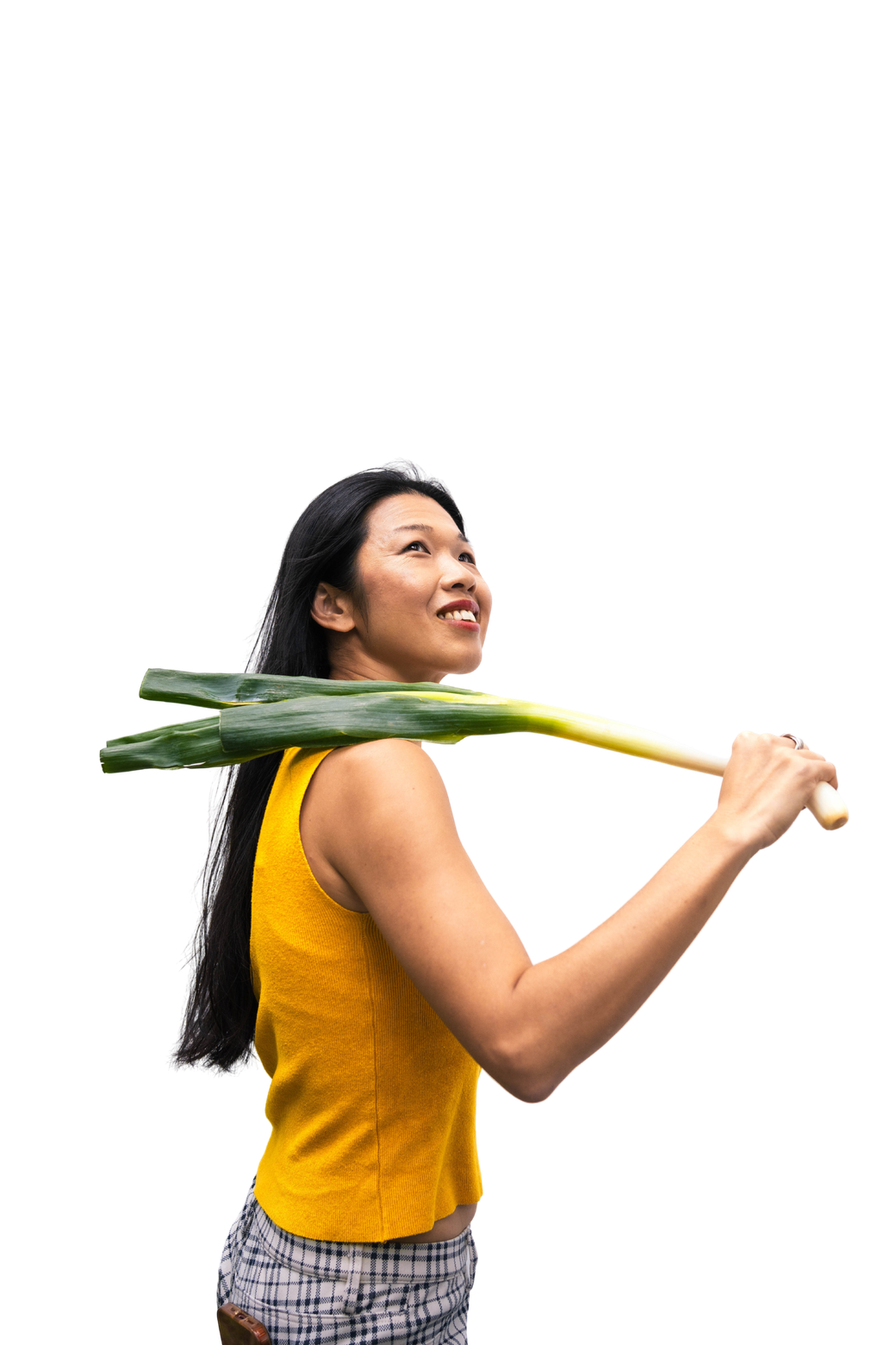 Tammie smiling upwards, a whole leek resting on her shoulder